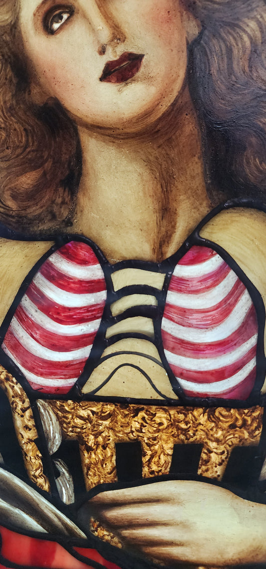 Close-up of a detailed painting with a face, striped elements, and gold accents.